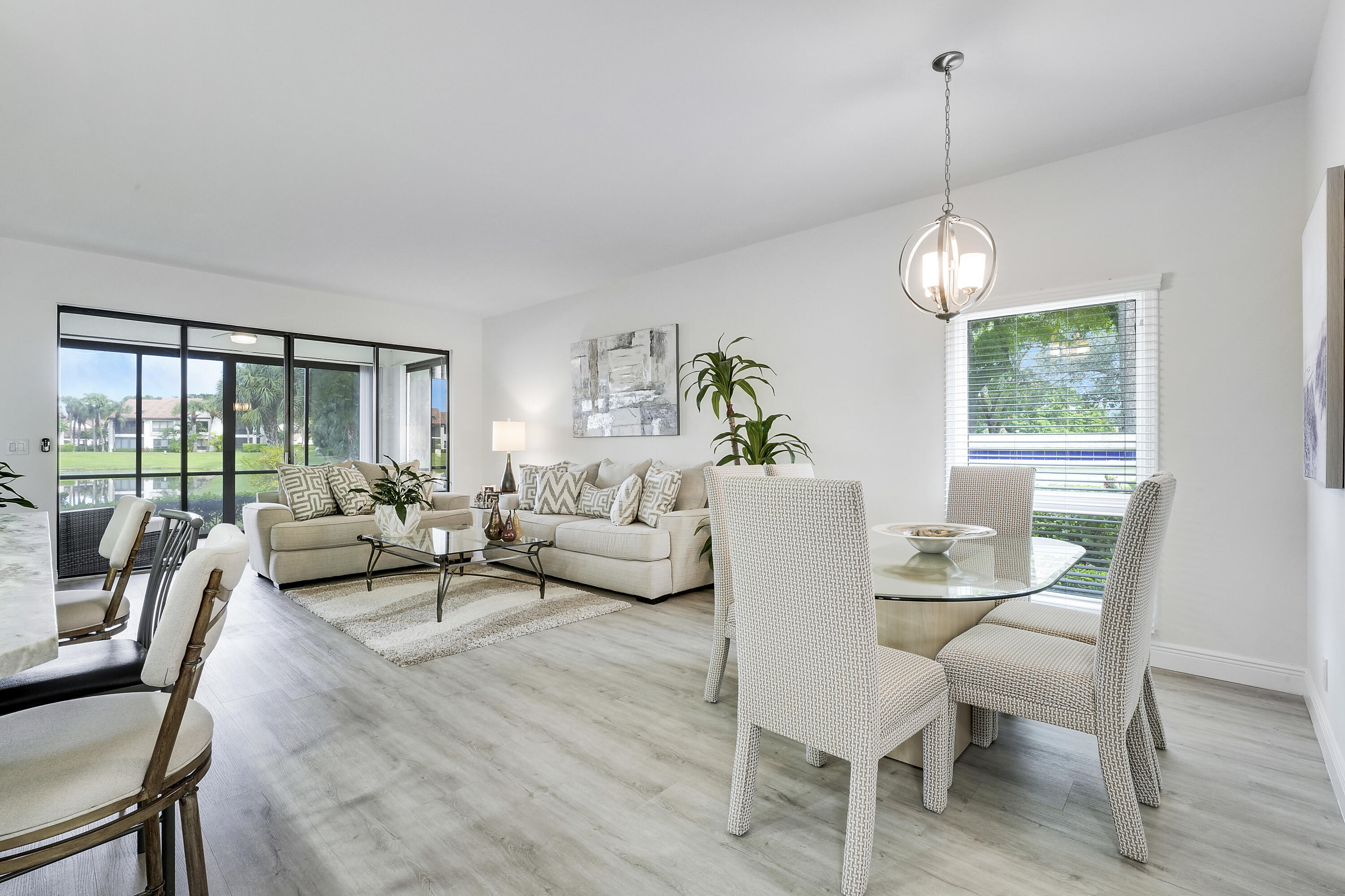 7860 Seville Place, Unit 2203 Boca Raton, FL 33433 - Photo 5 of 43 a living room with furniture a window and a table
