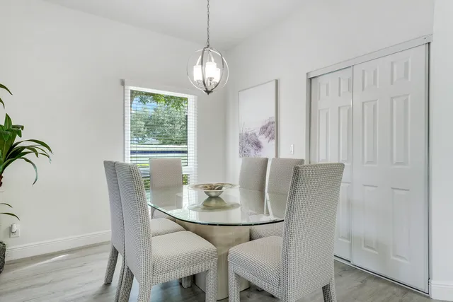 a living room with furniture potted plant and windows