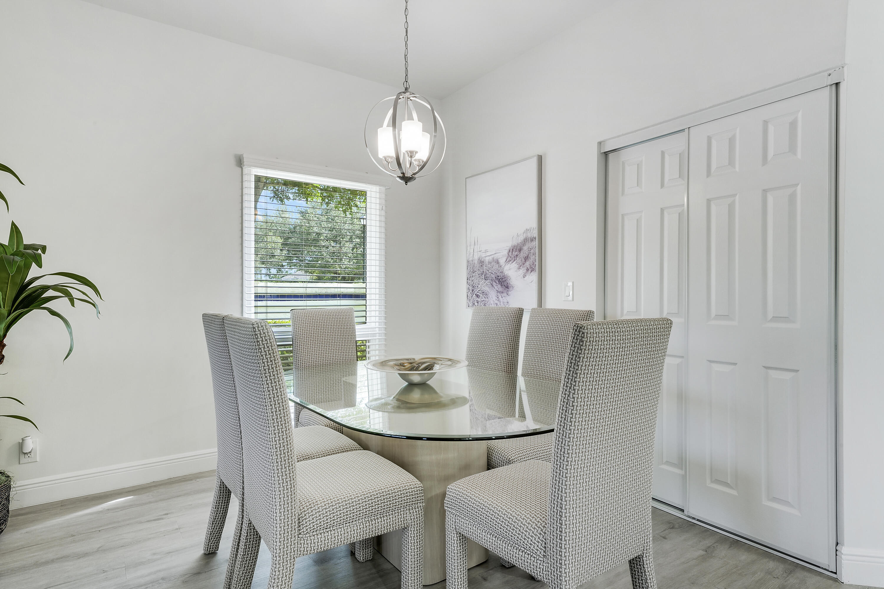 7860 Seville Place, Unit 2203 Boca Raton, FL 33433 - Photo 6 of 43 a view of a dining room with furniture window and wooden floor