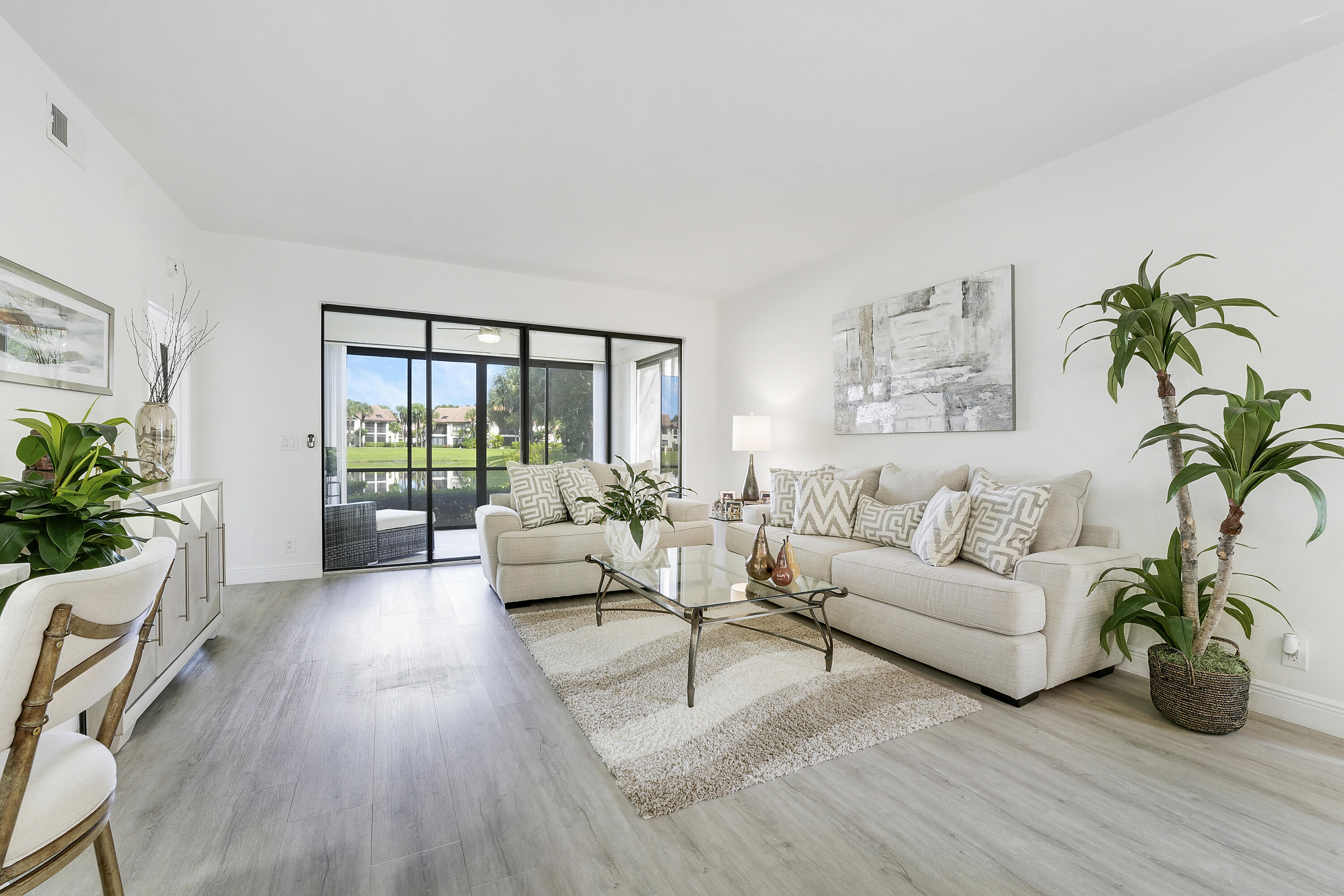 7860 Seville Place, Unit 2203 Boca Raton, FL 33433 - Photo 7 of 43 a living room with furniture potted plant and windows