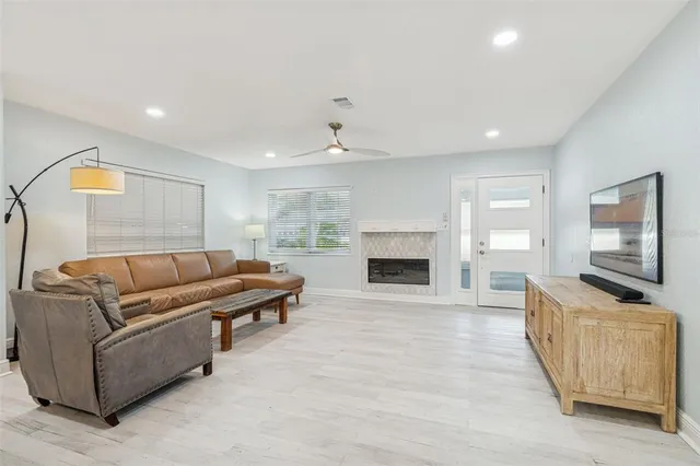 a kitchen with kitchen island granite countertop a table chairs sink and cabinets