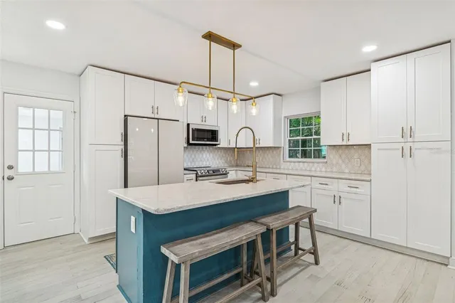 a bedroom with a large bed and a chandelier