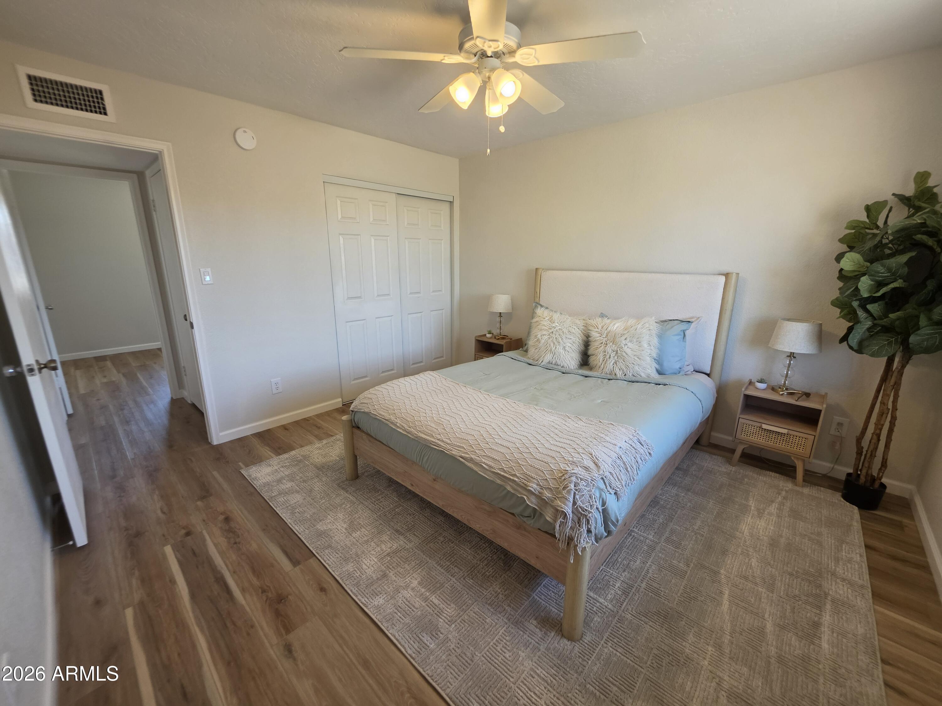 46 East McLellan Road Mesa, AZ 85201 - Photo 8 of 18 a bedroom with a bed and a chandelier