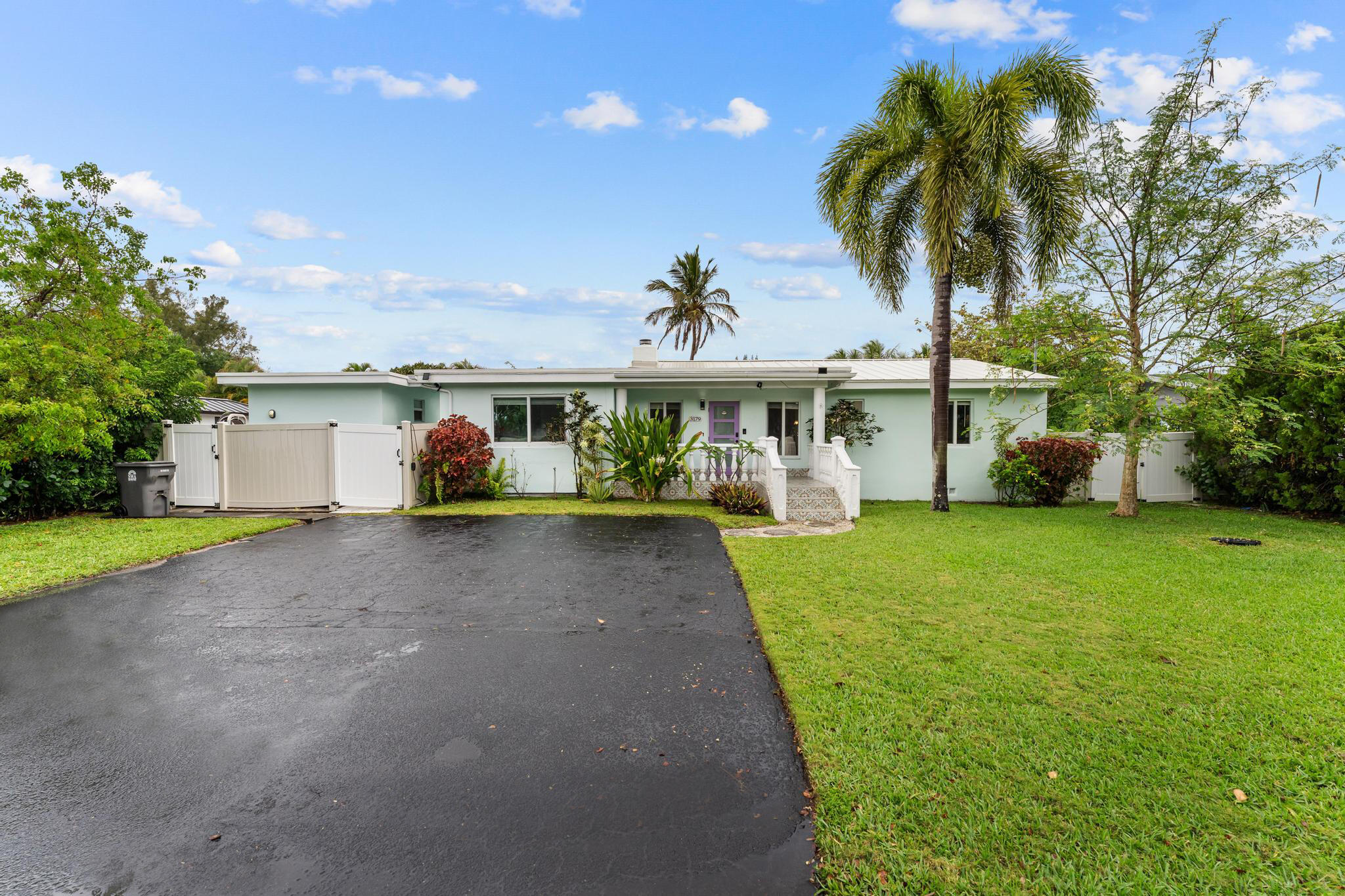 3179 Melaleuca Road West Palm Beach, FL 33406 - Photo 1 of 49 a view of a white house with a big yard and potted plants