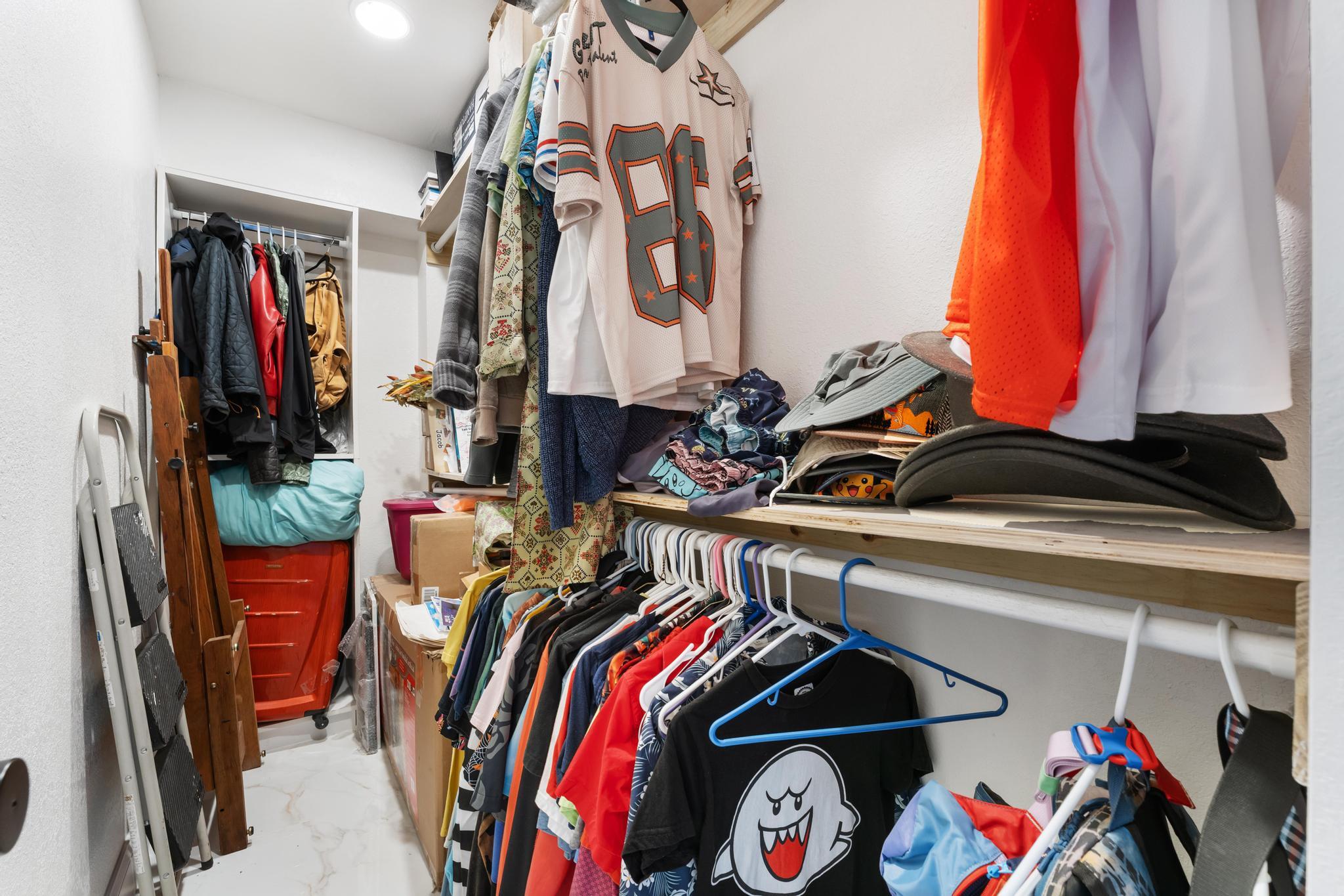 3179 Melaleuca Road West Palm Beach, FL 33406 - Photo 15 of 49 a view of walk in closet with clothes and shoes