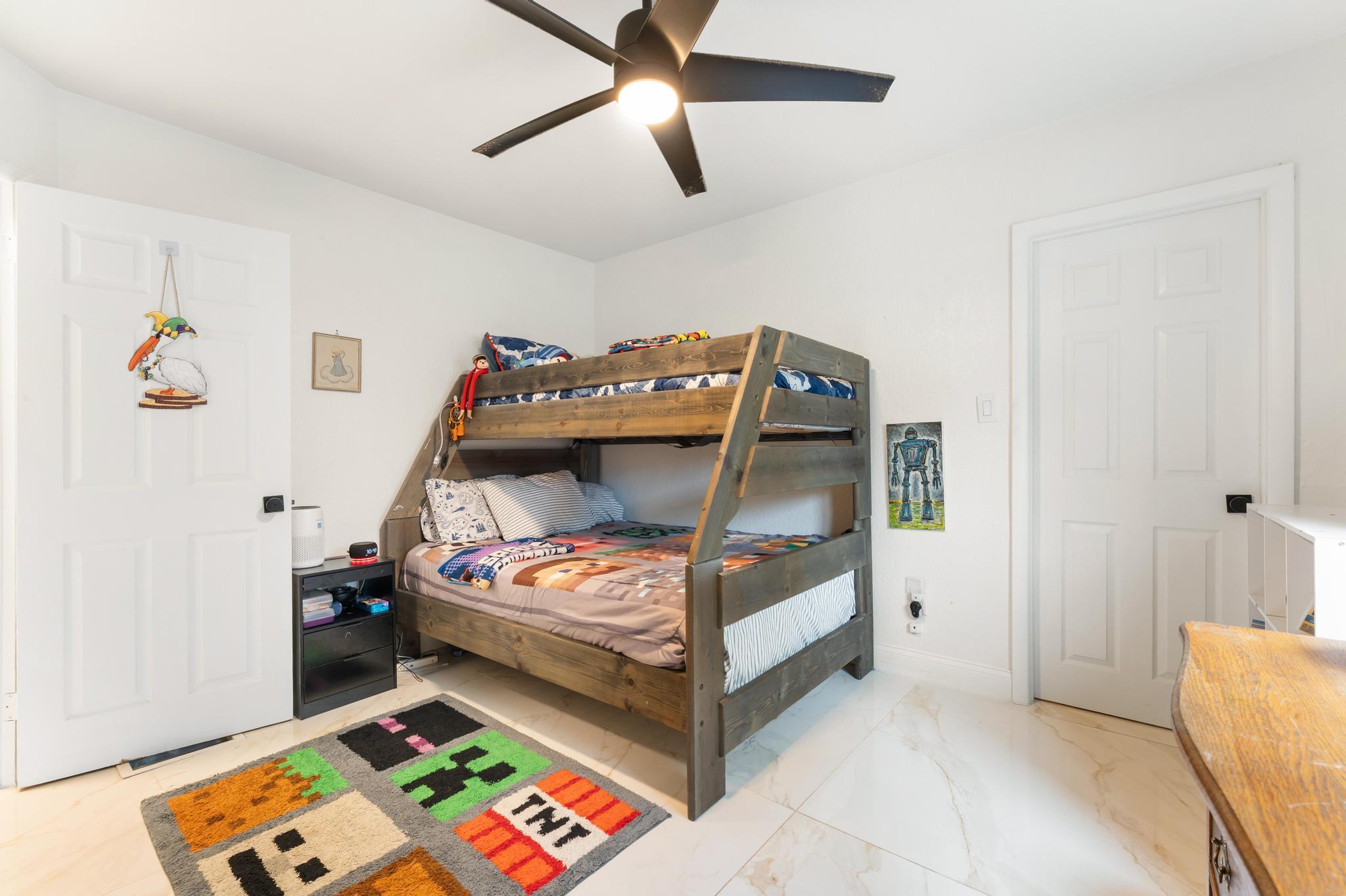 3179 Melaleuca Road West Palm Beach, FL 33406 - Photo 17 of 49 a bedroom with bed and a baby crib