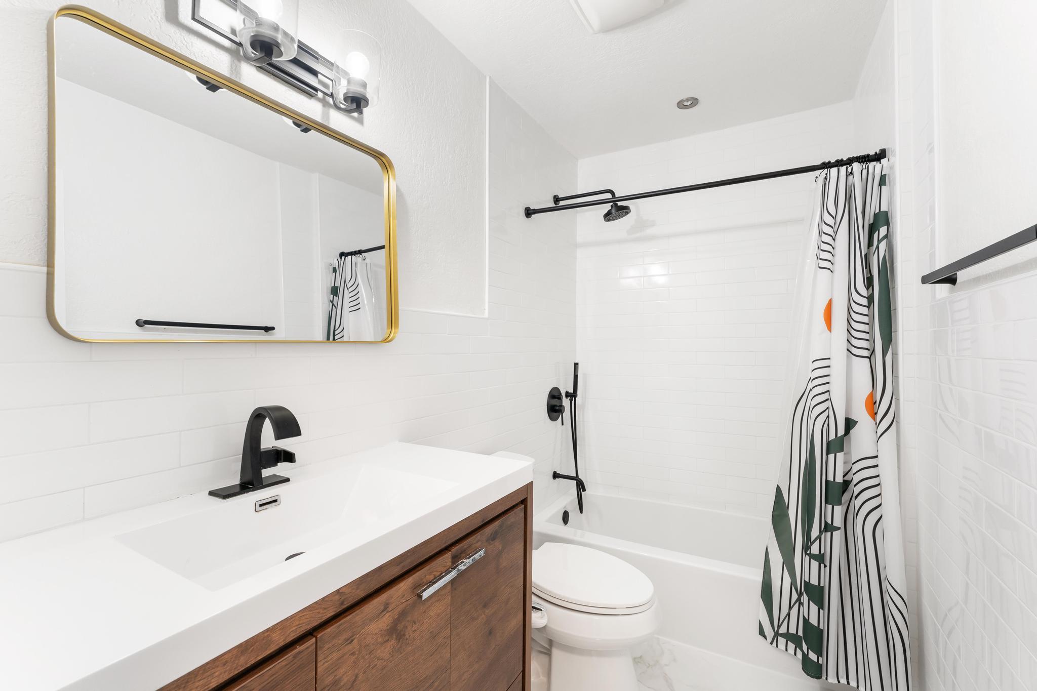 3179 Melaleuca Road West Palm Beach, FL 33406 - Photo 19 of 49 a bathroom with a sink a toilet a mirror and shower