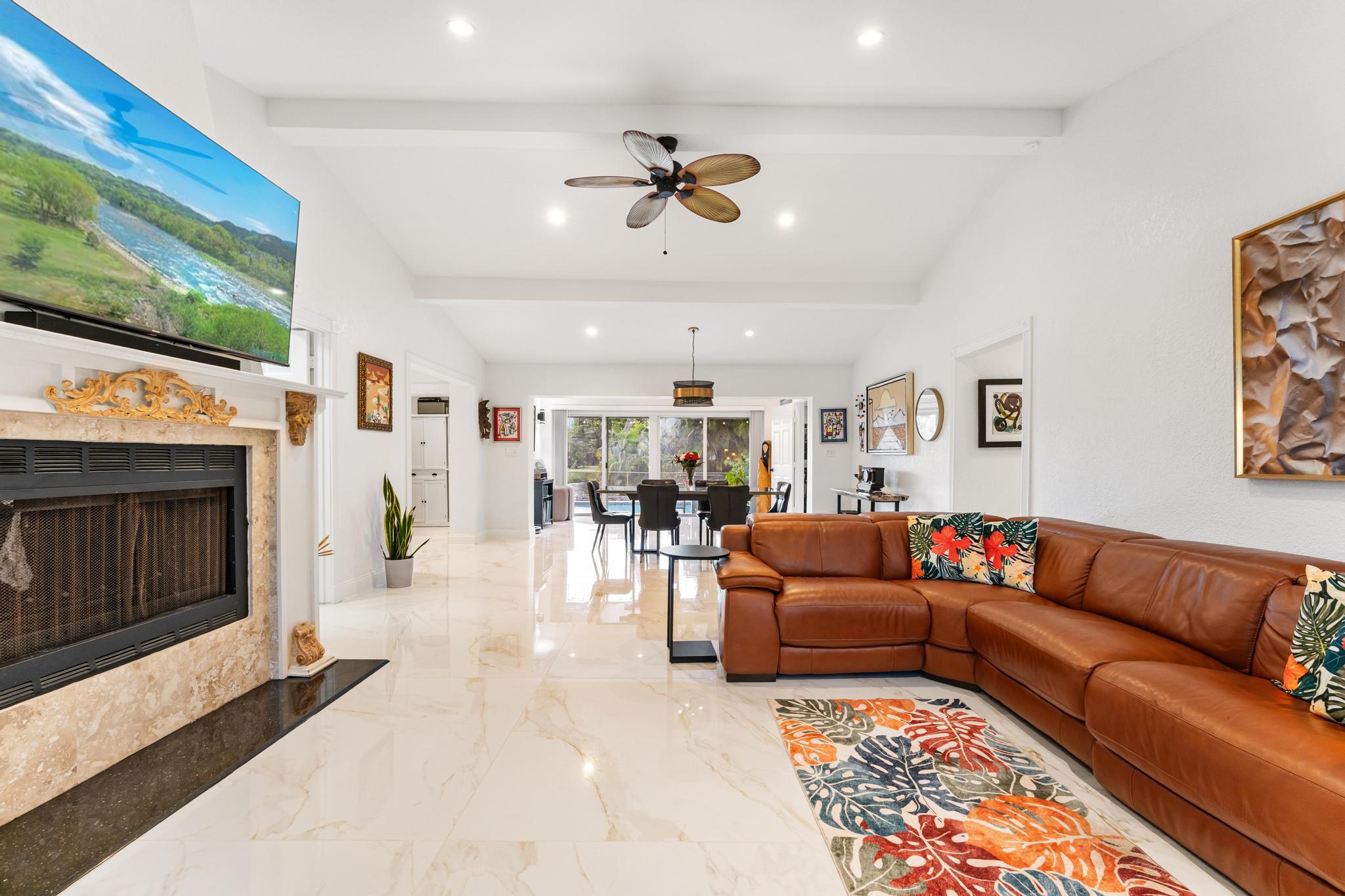 3179 Melaleuca Road West Palm Beach, FL 33406 - Photo 3 of 49 a living room with furniture and a fireplace