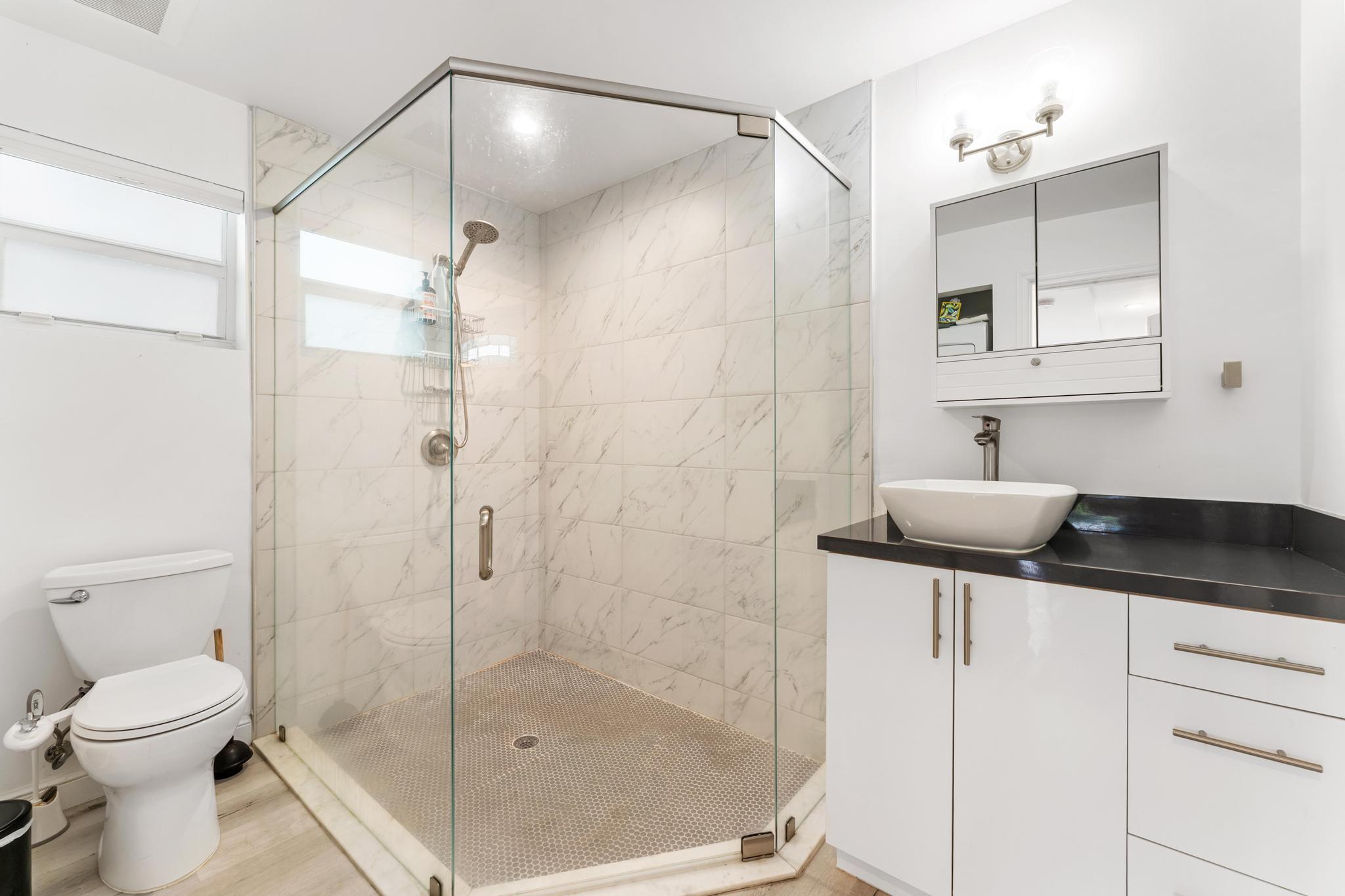 3179 Melaleuca Road West Palm Beach, FL 33406 - Photo 35 of 49 a bathroom with a granite countertop sink a toilet and shower