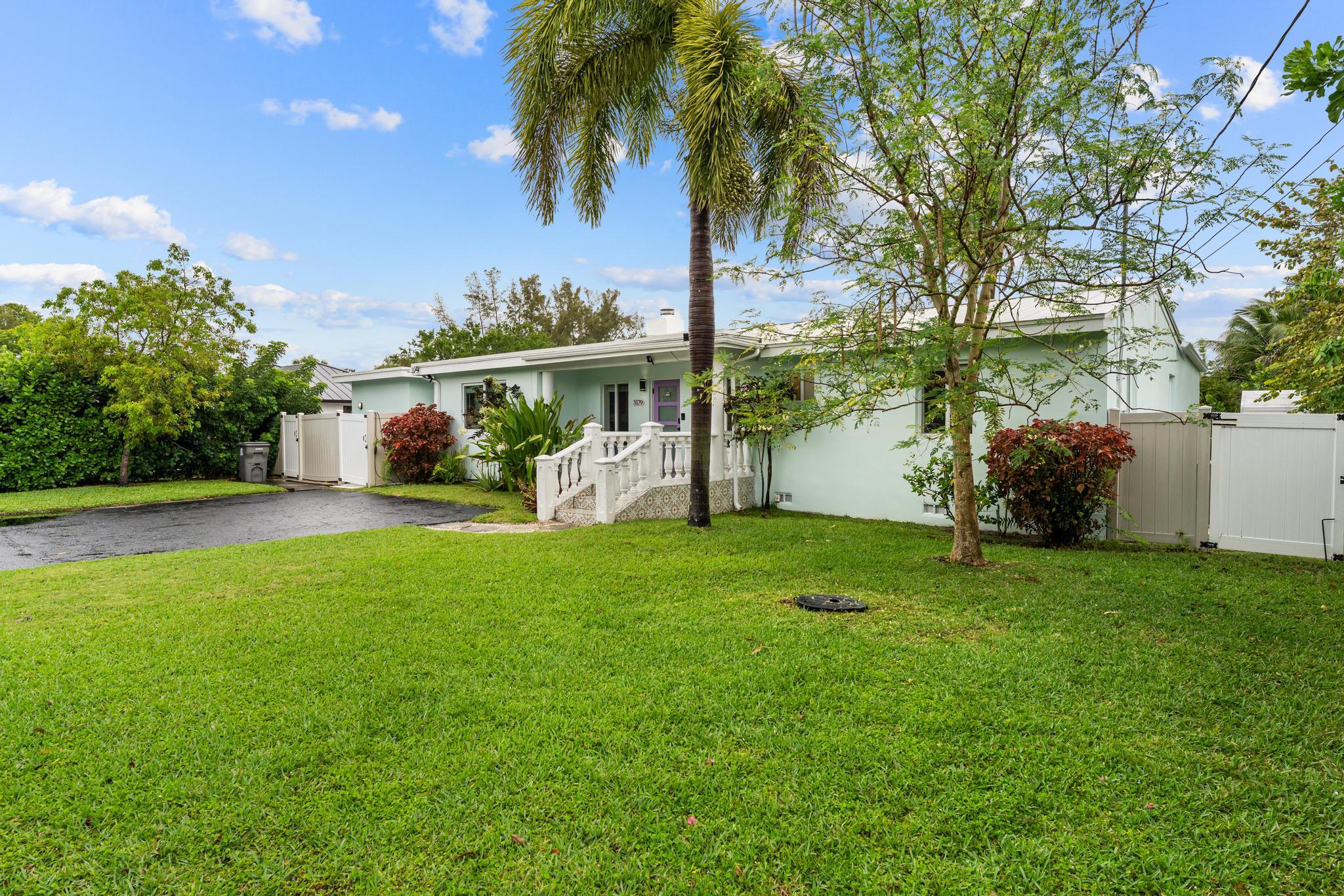 3179 Melaleuca Road West Palm Beach, FL 33406 - Photo 37 of 49 a view of a house with a yard
