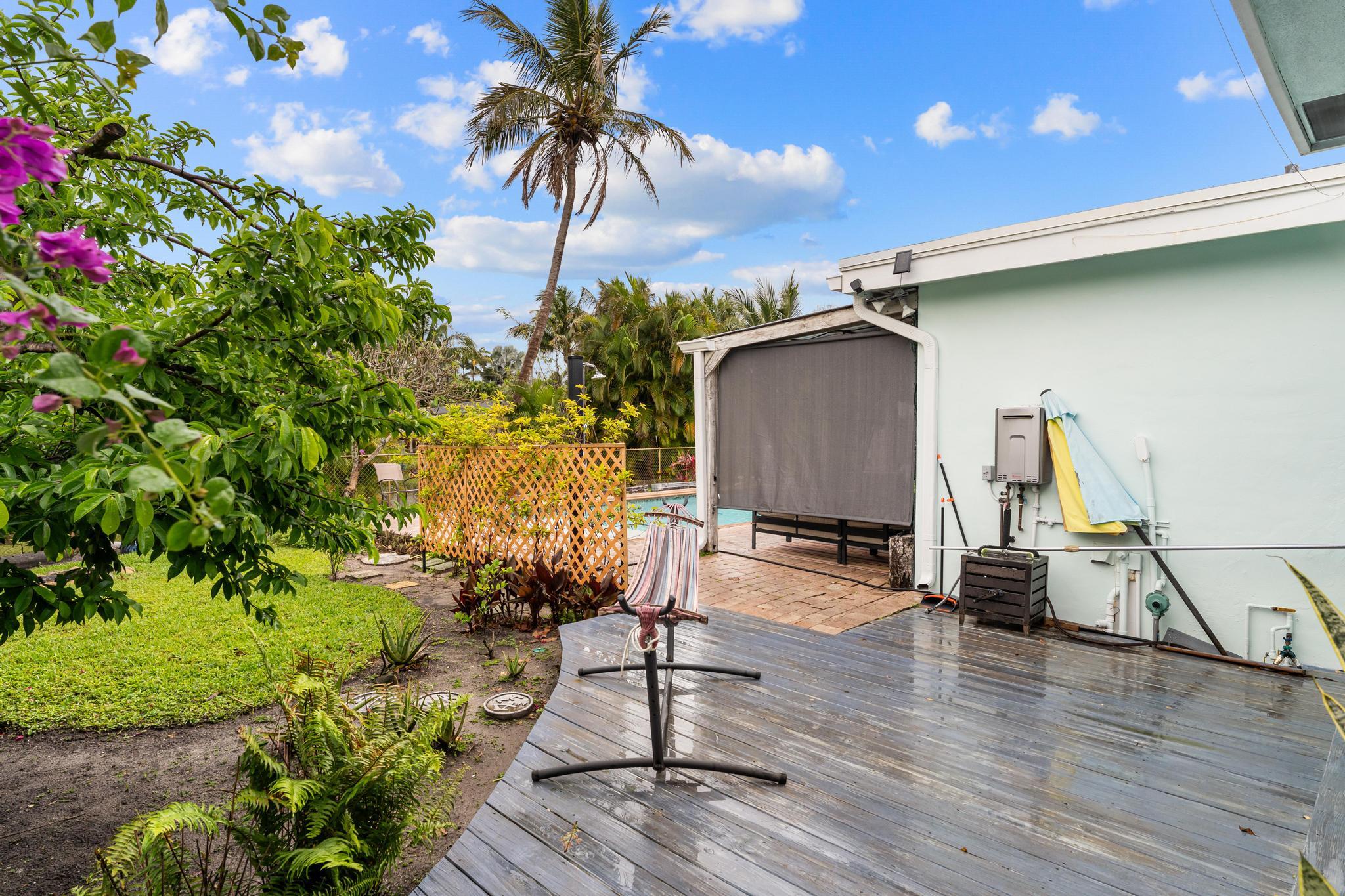 3179 Melaleuca Road West Palm Beach, FL 33406 - Photo 38 of 49 a view of a patio with table and chairs and potted plants
