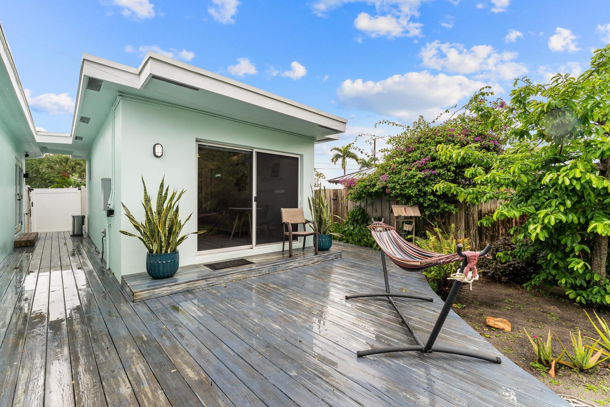 3179 Melaleuca Road West Palm Beach, FL 33406 - Photo 40 of 49 a view of a house with backyard sitting area and wooden floor
