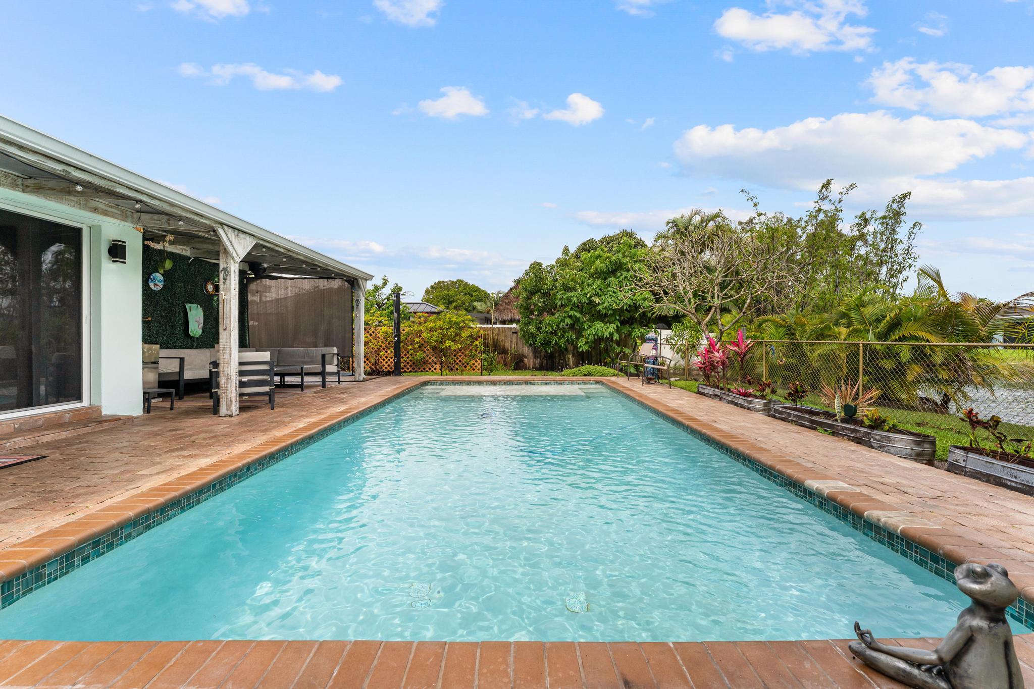 3179 Melaleuca Road West Palm Beach, FL 33406 - Photo 42 of 49 a swimming pool with outdoor seating and yard