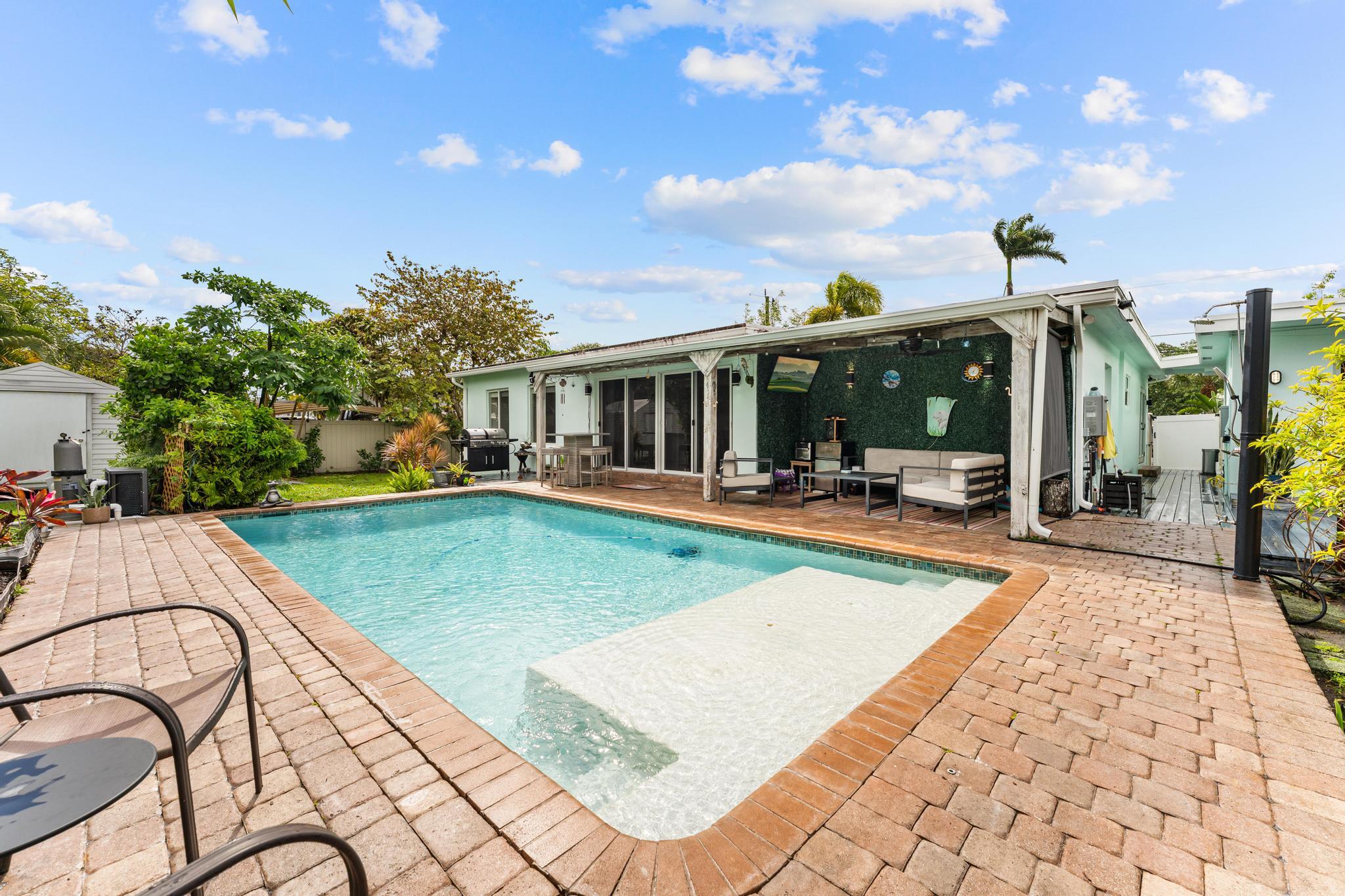3179 Melaleuca Road West Palm Beach, FL 33406 - Photo 43 of 49 a view of a swimming pool with a patio