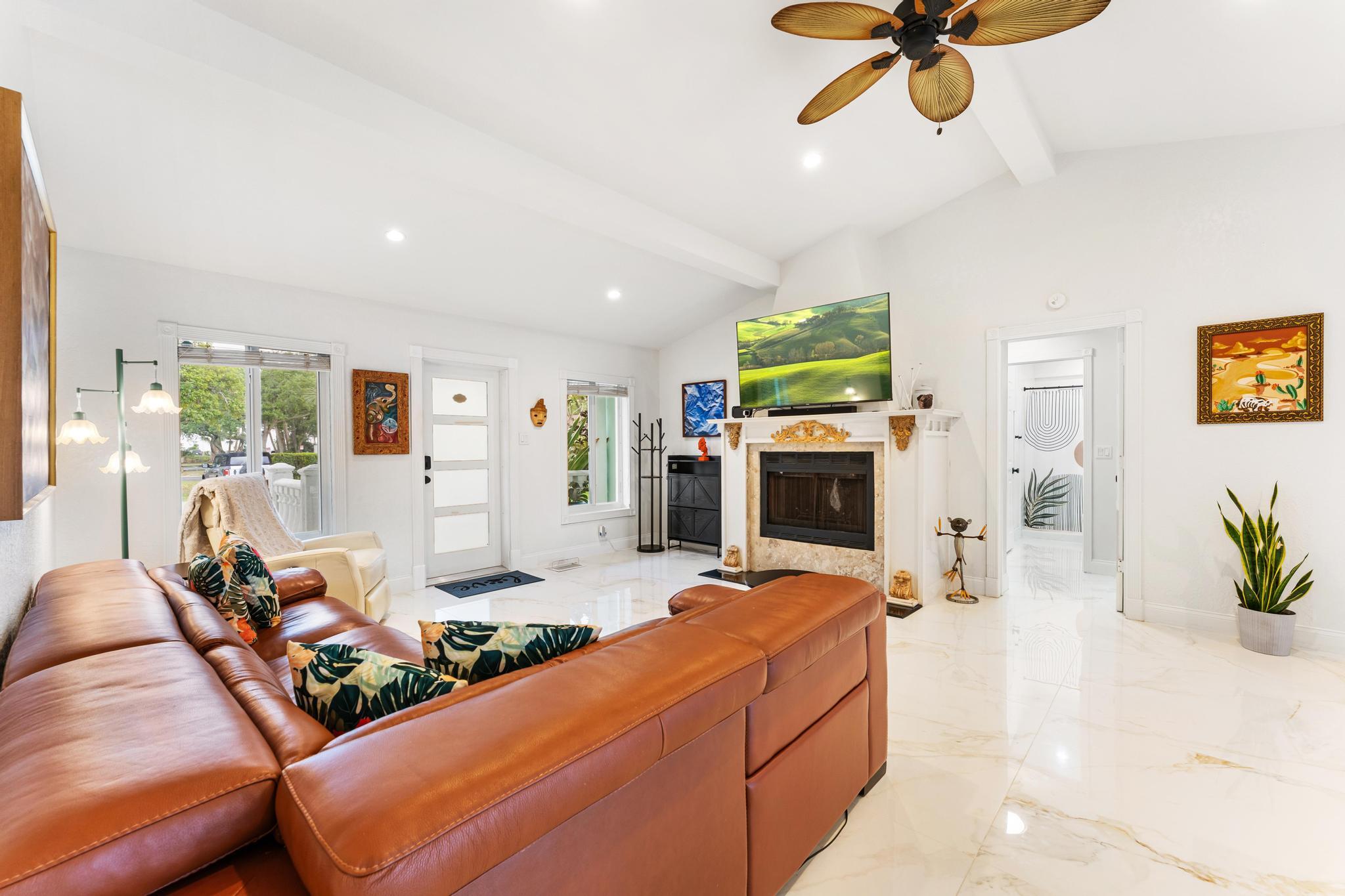 3179 Melaleuca Road West Palm Beach, FL 33406 - Photo 6 of 49 a living room with furniture fireplace and flat screen tv