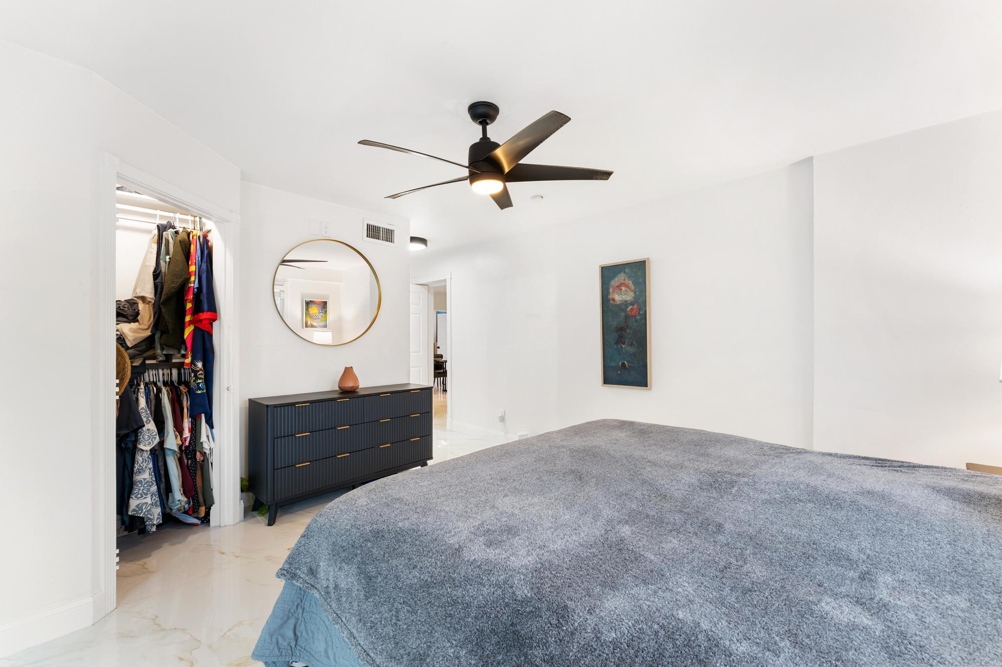 3179 Melaleuca Road West Palm Beach, FL 33406 - Photo 8 of 49 a bedroom with a bed and a chandelier