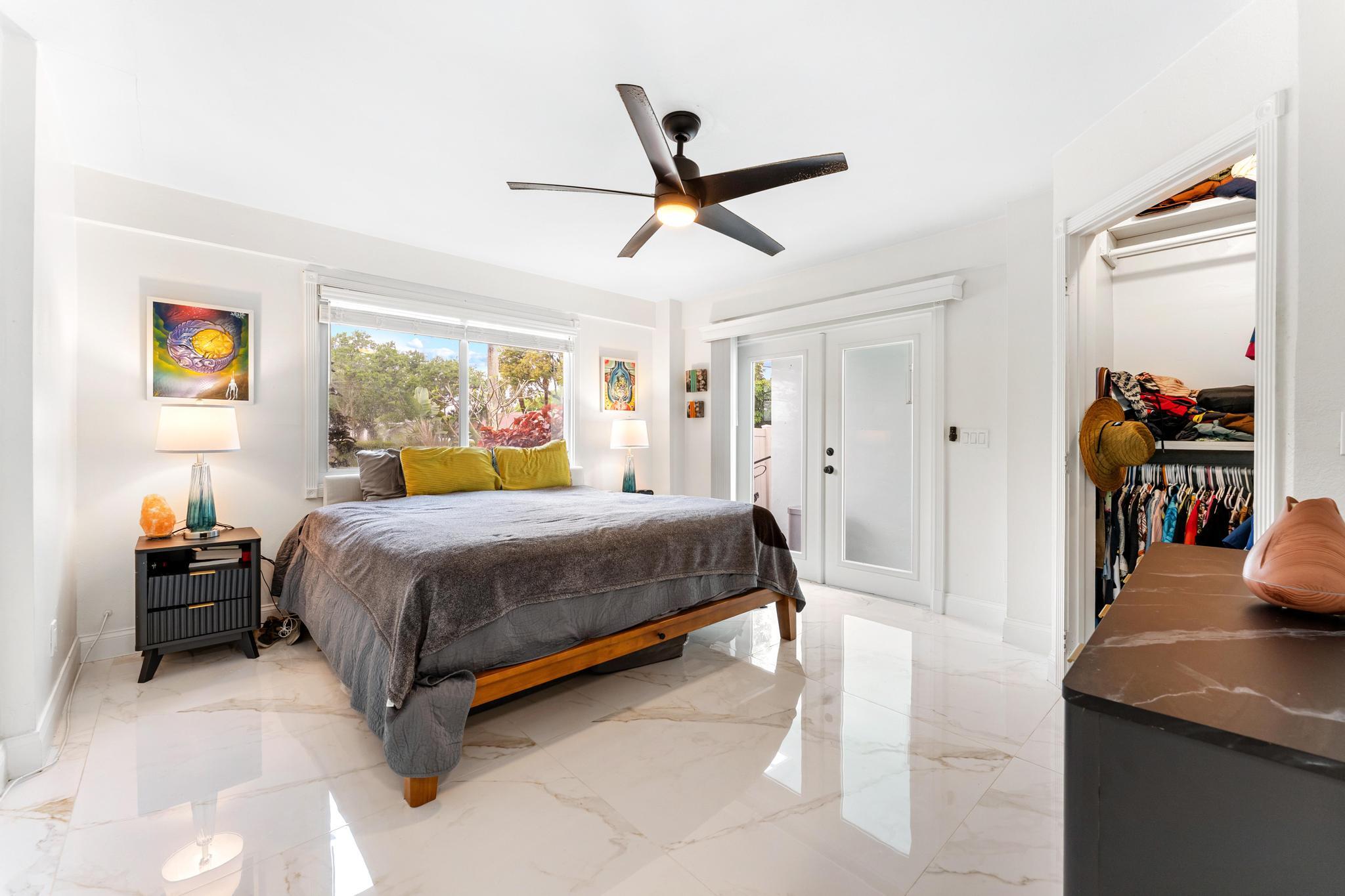 3179 Melaleuca Road West Palm Beach, FL 33406 - Photo 9 of 49 a bedroom with a bed and wooden floor