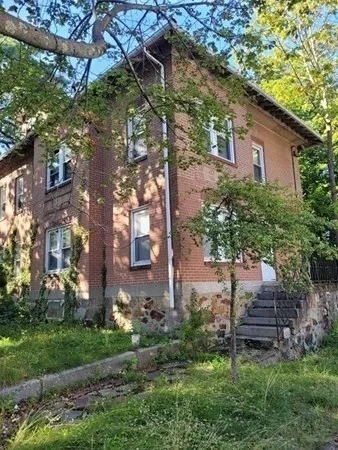 a backyard of a house with a yard and outdoor seating