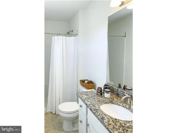 a bedroom with a bed and a tv