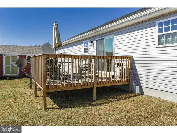 a view of a porch with a table and a chair