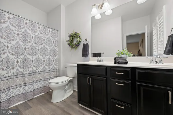 a bathroom with a sink toilet and a mirror