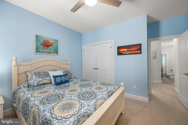 a bedroom with a bed and a painting on the wall