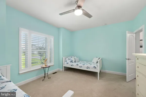 a room with a baby bed baby crib and dresser