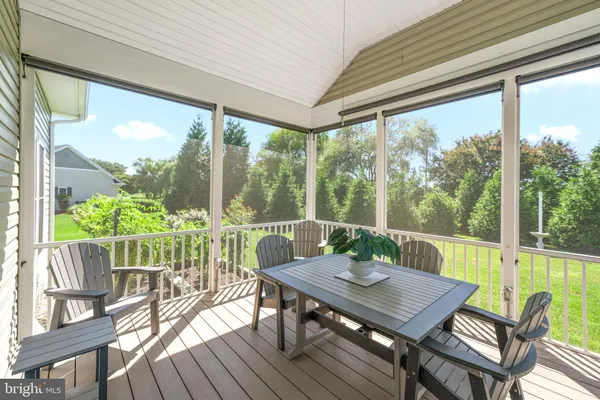 a view of backyard with seating space and trees