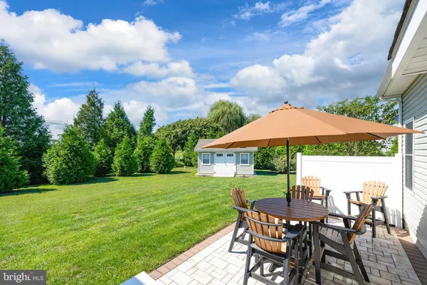 a view of a chair and table in the backyard