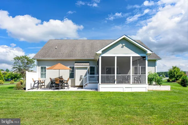 a front view of a house with a yard and porch