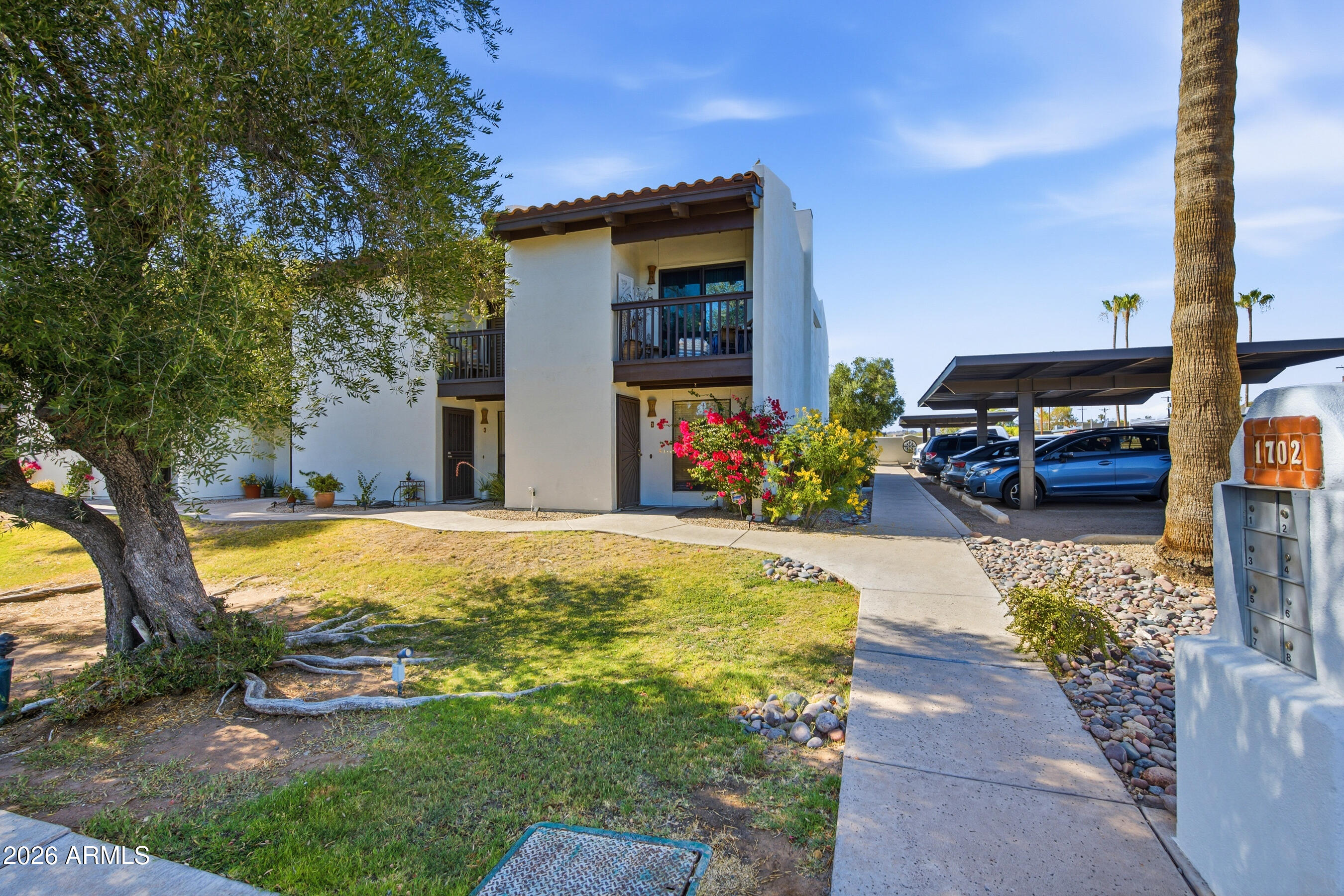 1702 East Ocotillo Road, Unit 1 Phoenix, AZ 85016 - Photo 1 of 27 a swimming pool with outdoor seating and yard