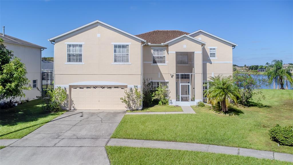 5404 Crepe Myrtle Circle Kissimmee, FL 34758 - Photo 1 of 1 a front view of a house with a yard and garage