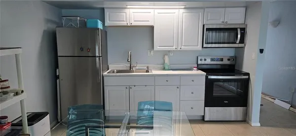a kitchen with a refrigerator and cabinets