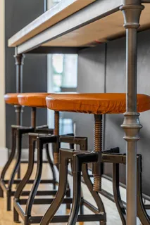 a kitchen with stainless steel appliances kitchen island granite countertop a table chairs and a refrigerator