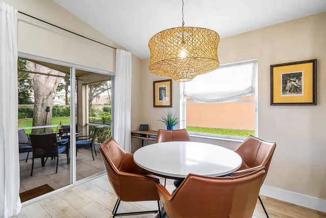 a dining room with furniture and wooden floor