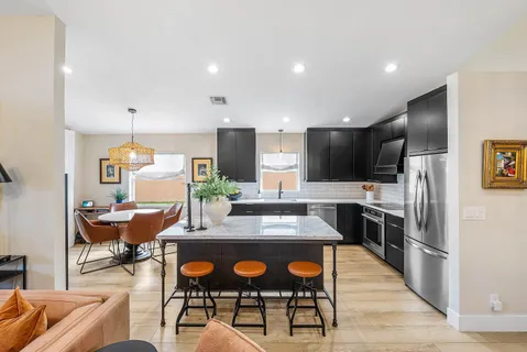 a living room with furniture flat screen tv and wooden floor