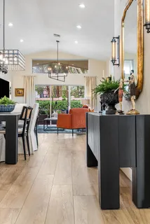 a dining room with furniture and a chandelier