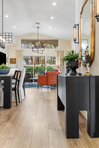 a dining room with furniture and a chandelier