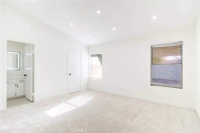 an empty room with windows and closet