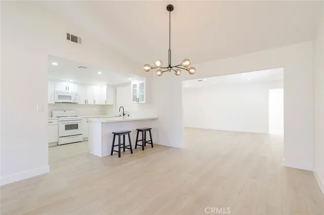 a view of a kitchen with a sink and microwave