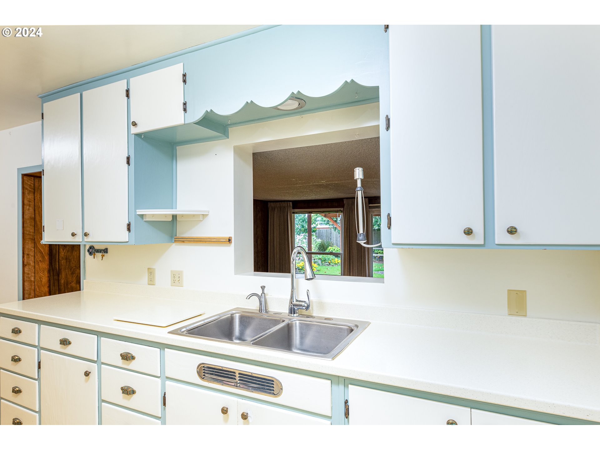 1039 Nancy Avenue Springfield, OR 97477 - Photo 12 of 40 a kitchen with stainless steel appliances granite countertop a sink and a white cabinets