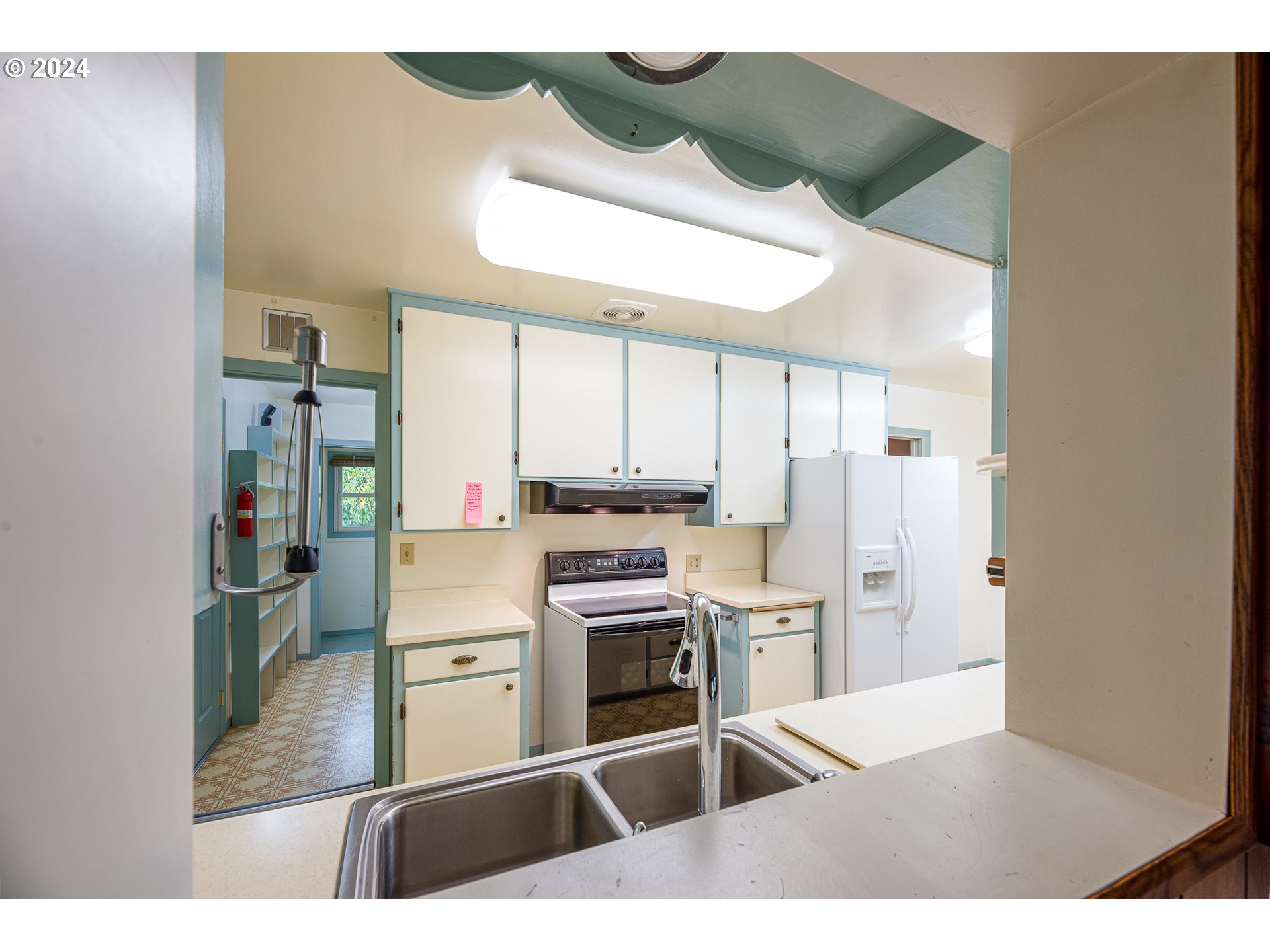 1039 Nancy Avenue Springfield, OR 97477 - Photo 13 of 40 a kitchen with stainless steel appliances kitchen island granite countertop a refrigerator and a stove top oven