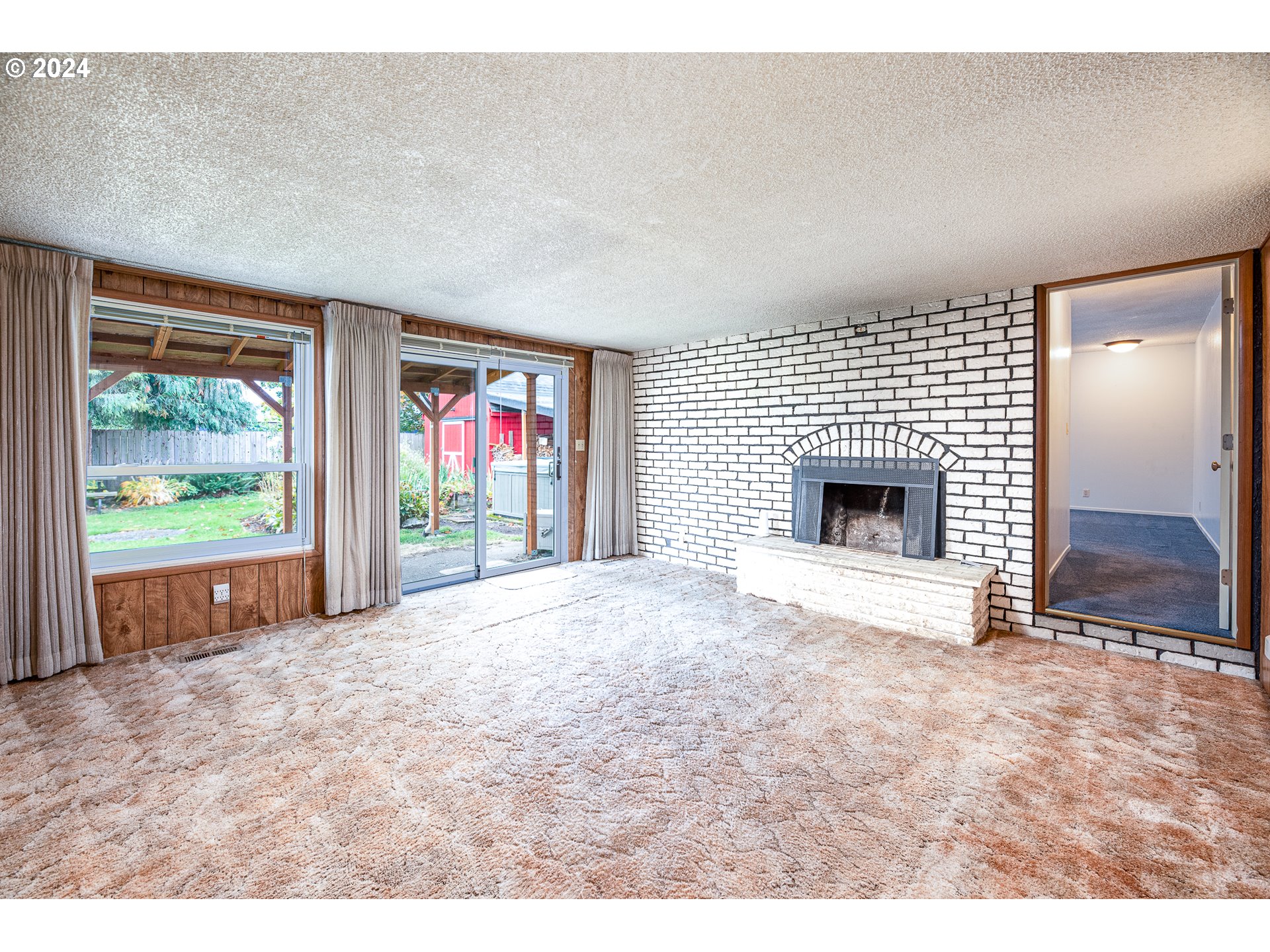 1039 Nancy Avenue Springfield, OR 97477 - Photo 14 of 40 a view of an empty room with a fireplace and windows