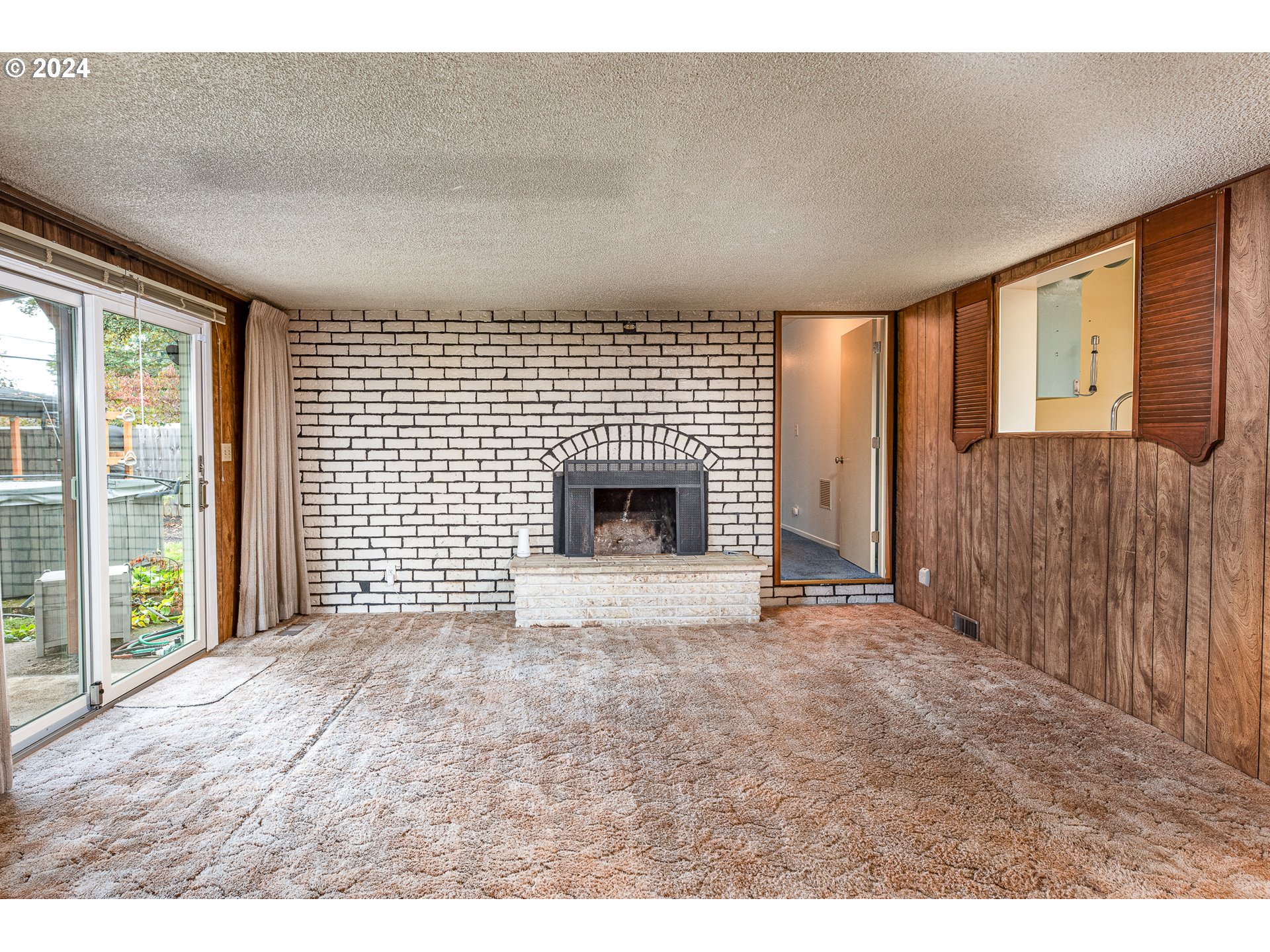 1039 Nancy Avenue Springfield, OR 97477 - Photo 15 of 40 a view of an empty room with a fireplace and a window