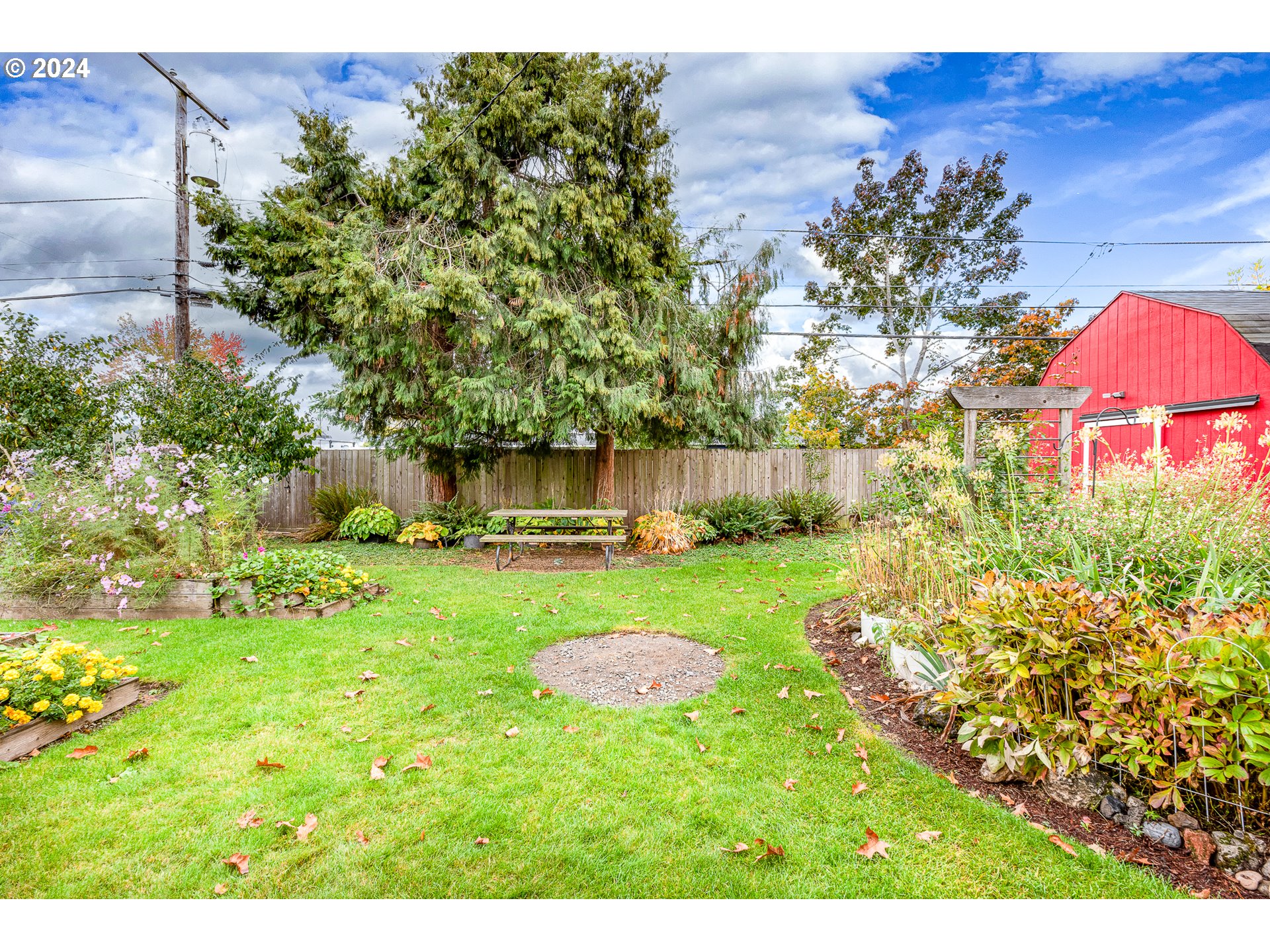 1039 Nancy Avenue Springfield, OR 97477 - Photo 34 of 40 a view of a backyard with plants and a garden