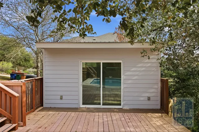 a view of balcony with wooden floor and trees