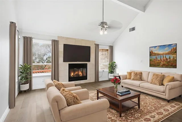 a living room with furniture and a fireplace