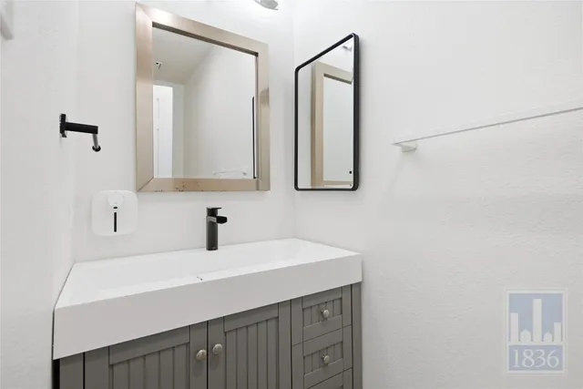 an empty room with a window and a ceiling fan