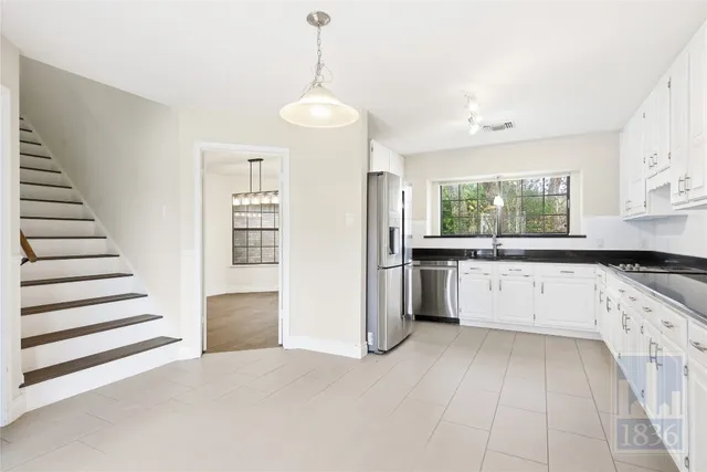 a view of a bedroom with closet and ceiling fan