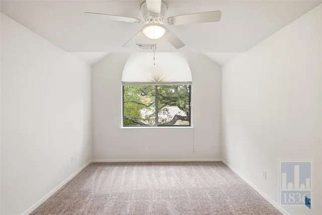 a view of empty room with a ceiling fan